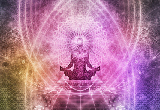 Image of someone siting in a meditation pose with cosmic colors radiating from their body